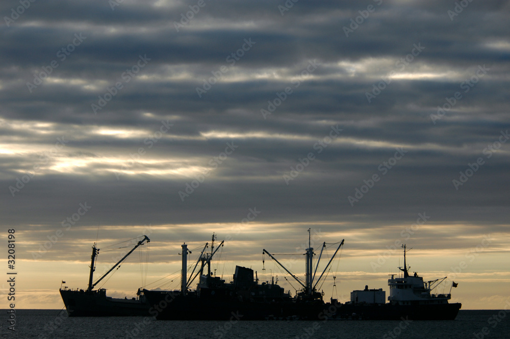 cargo boats at sunset