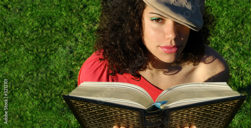 young woman reading a book in the evening
