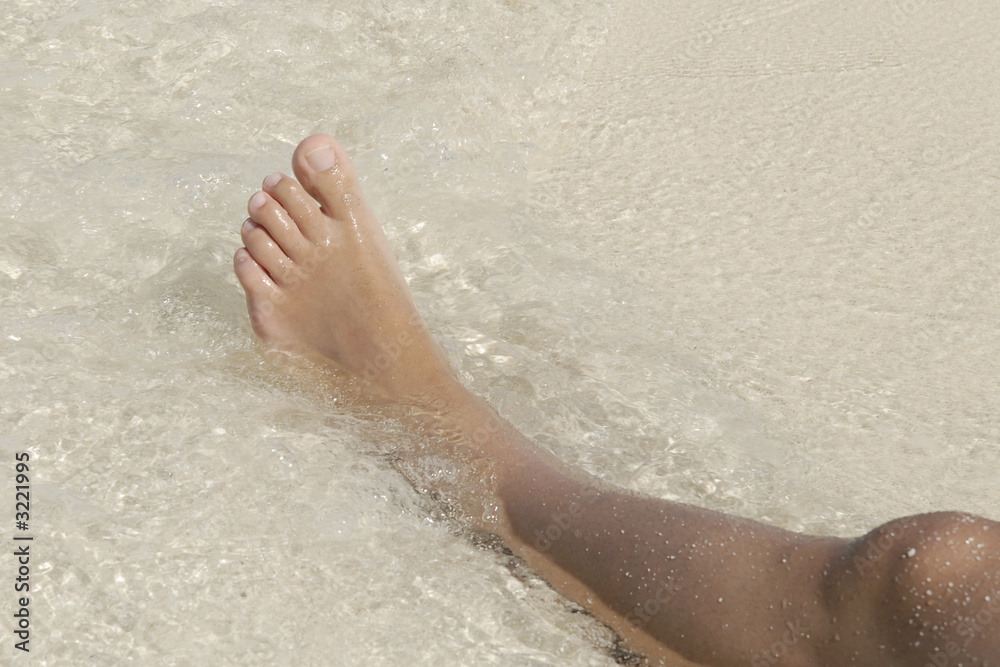 foot in the water at the sea