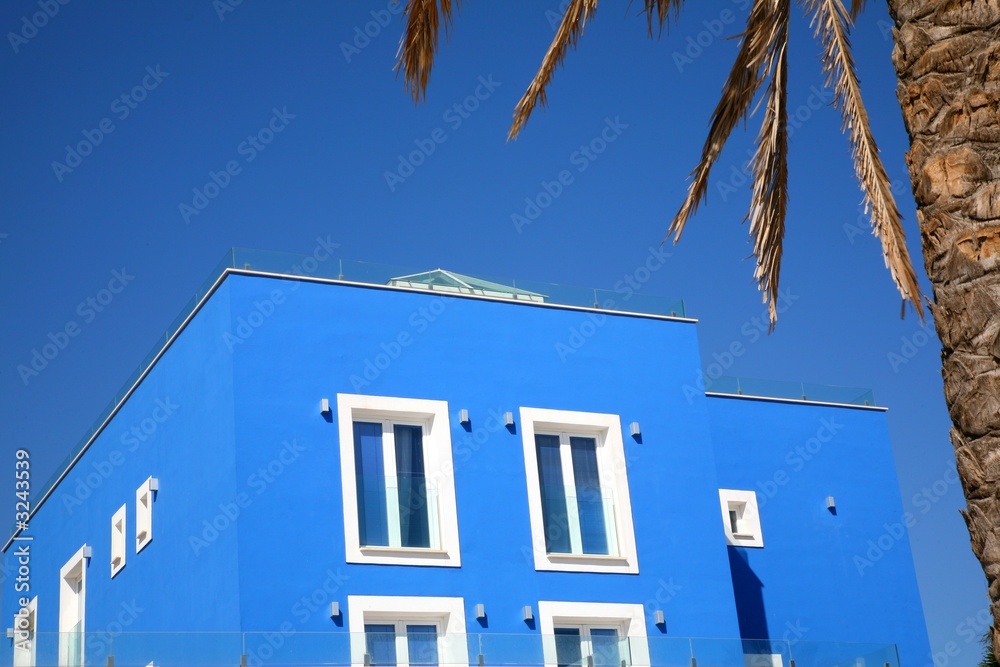 blue hotel with palm tree