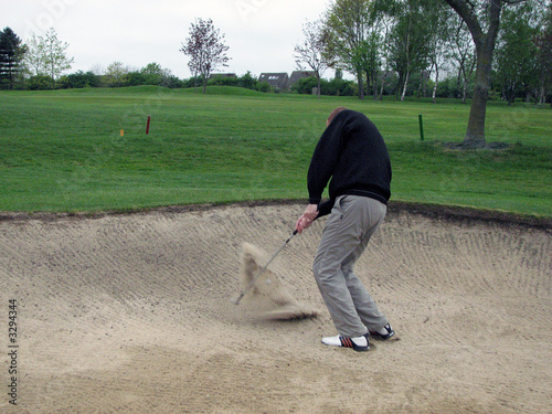 golfer stuck in a bunker