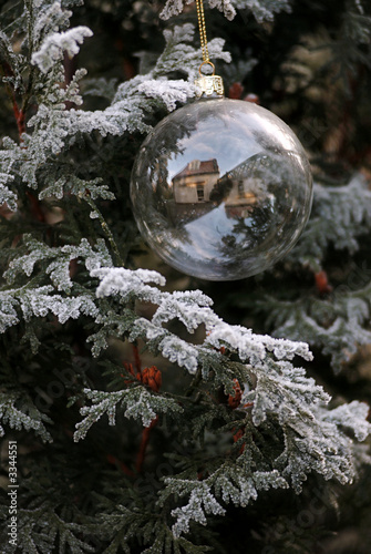 glass christmas ball on a tree with reflection and snow
