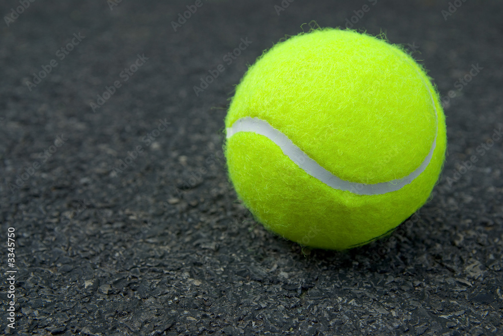 tennis ball on pavement
