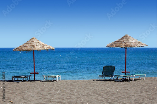 black beach umbrellas - greece