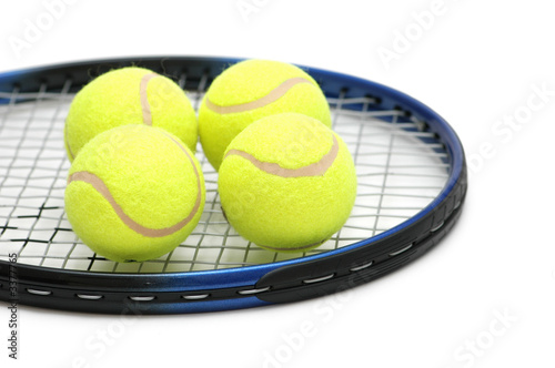 tennis balls on the racket - isolated on white