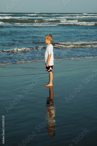 boy standinng on beach