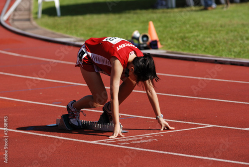 sportswoman running on the stadium photo