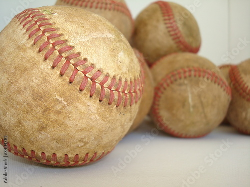 a bunch of old baseballs – three of four in series