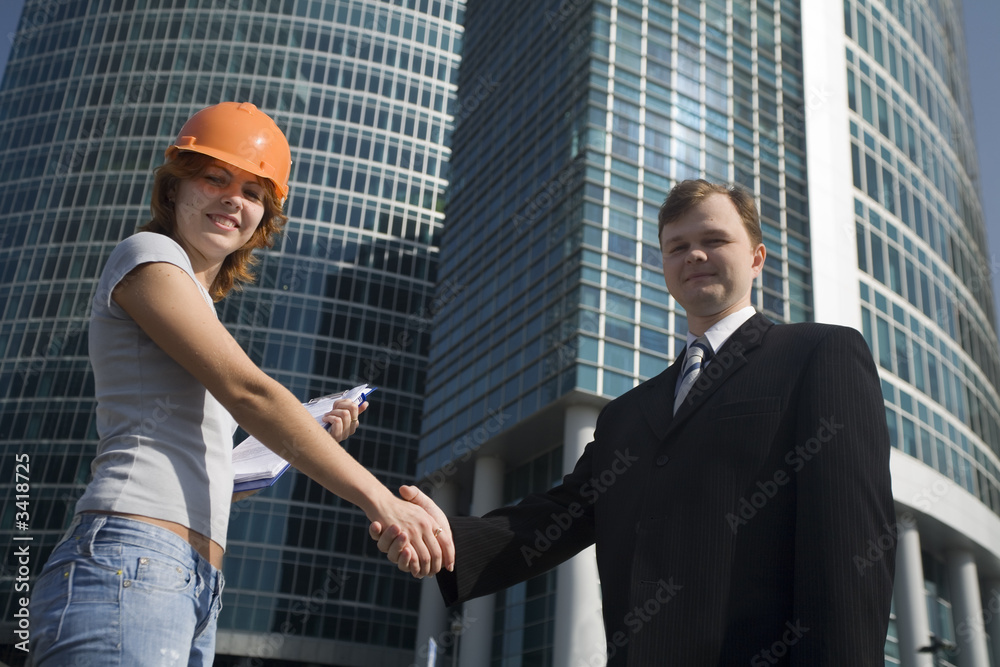 Handshake before new office building Handshake before new office building