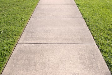 Sidewalk and grass converging lines