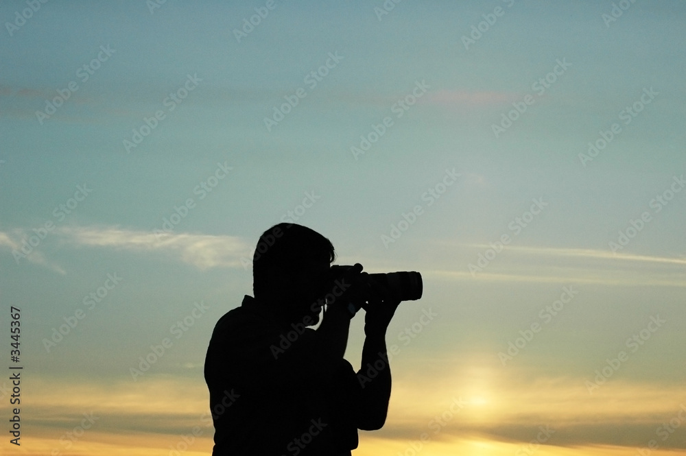 silhouette of a photographer during the sunset silhouette of a photographer during the sunset