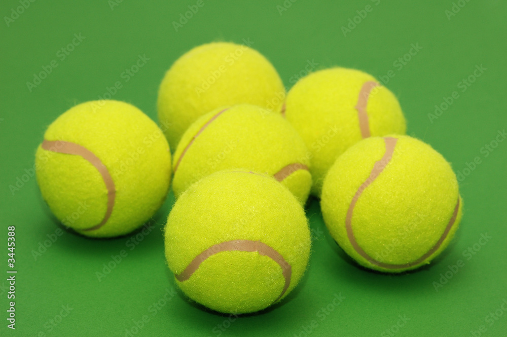 six tennis balls on the green background