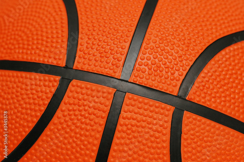 close up of orange basketball with black lines © Elnur