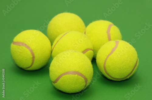 six tennis balls on the green background © Elnur