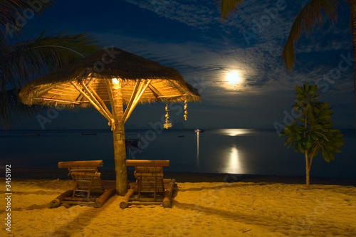 beach chairs at tropical resort - night scene photo