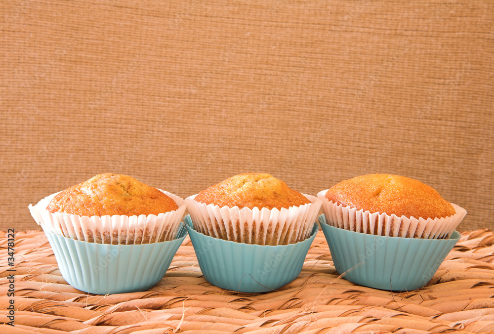 three muffins in blue cups three muffins in blue cups