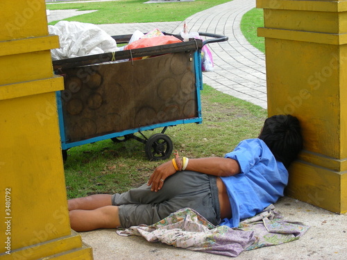 homless man sleeping on the ground