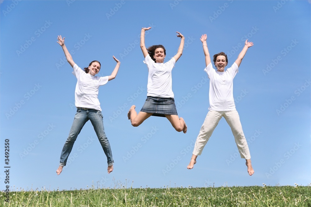 Three girlfriends in white T-shorts jump together Three girlfriends in white T-shorts jump together