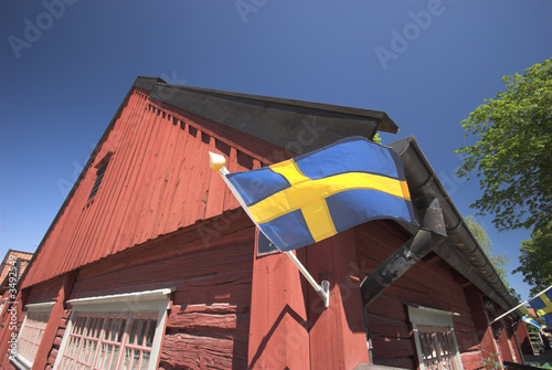 swedish flag and red  wooden house