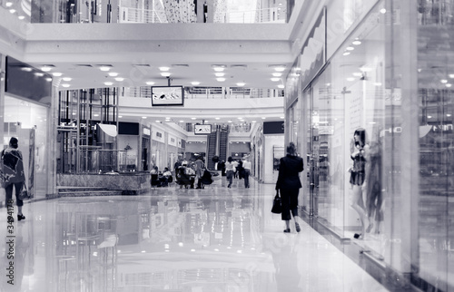 shoppers at shopping center, motion blur. tint blue