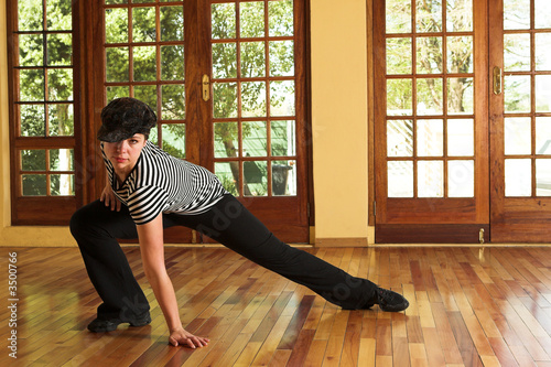 Sexy modern dancer in Black hat and striped top