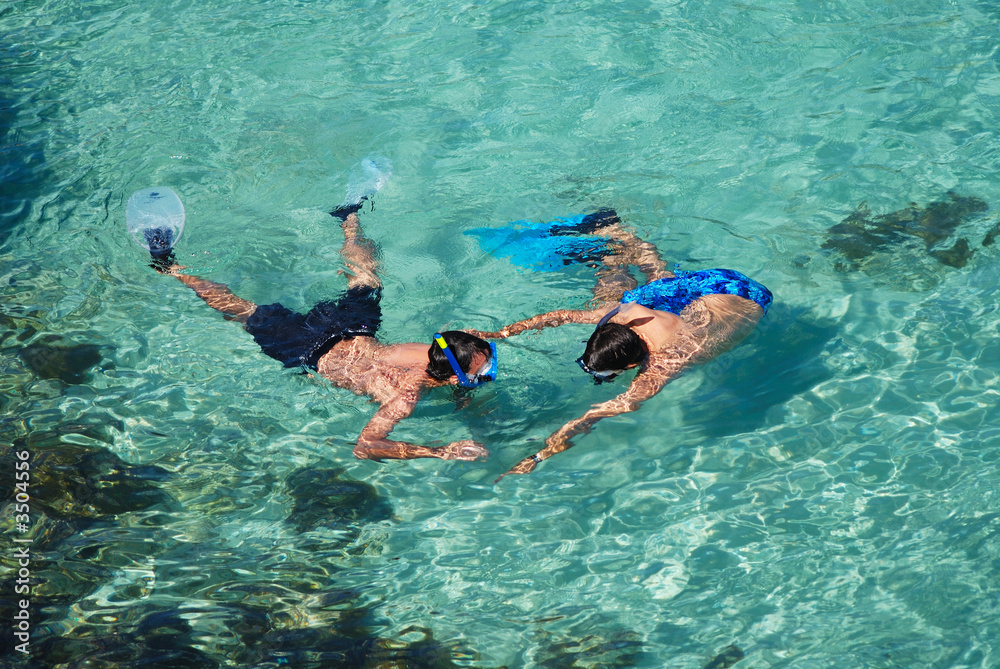 two men snorkelling in majorcan cove