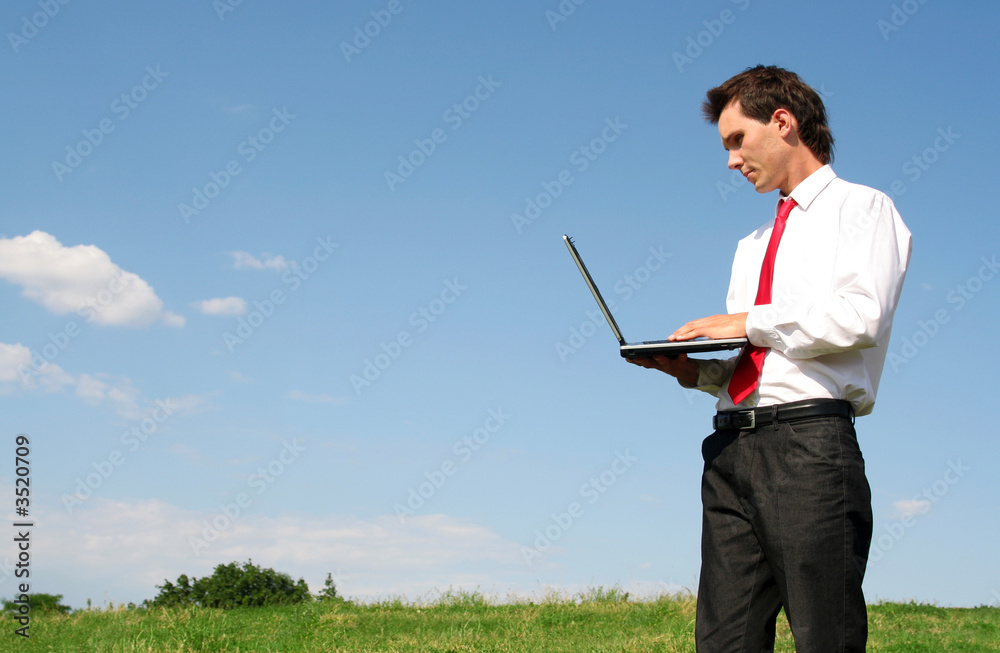 businessman using laptop outdoors