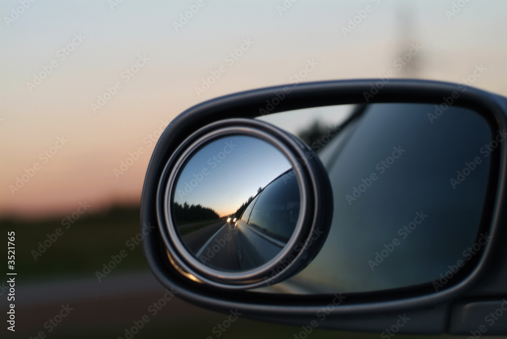 Highway reflected in glass of the automobile