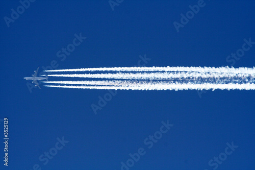  Airplane four engines aviation airport contrail clouds travel trip concept © portraitfoto.in