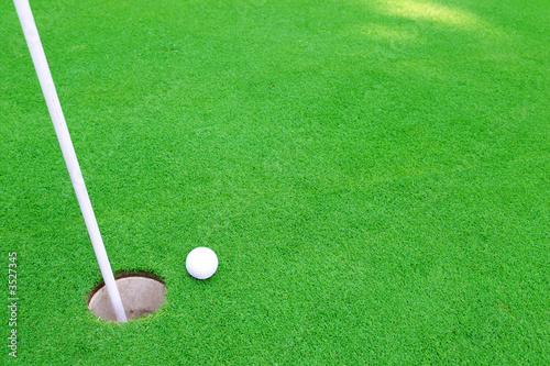 Golf ball on green to cup