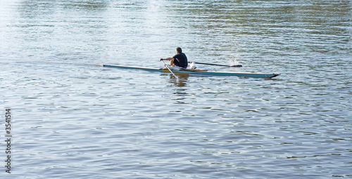 one single sculler rower oarsman rows in boat