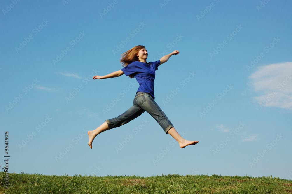 Jumping girl on a background sky Jumping girl on a background sky