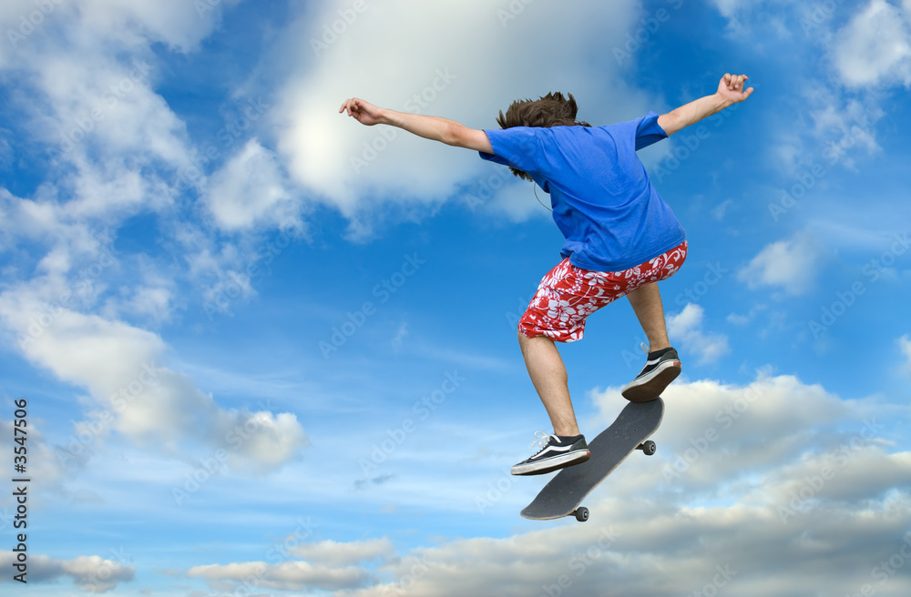 Teenager skater high jump against clear blue Teenager skater high jump against clear blue