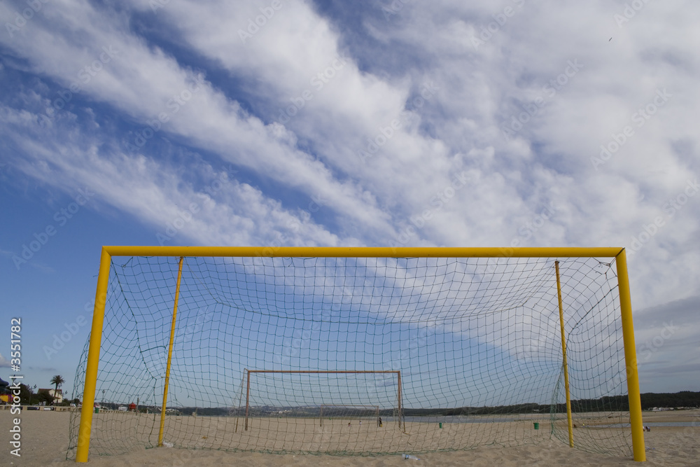 a lonely net of soccer in a beach