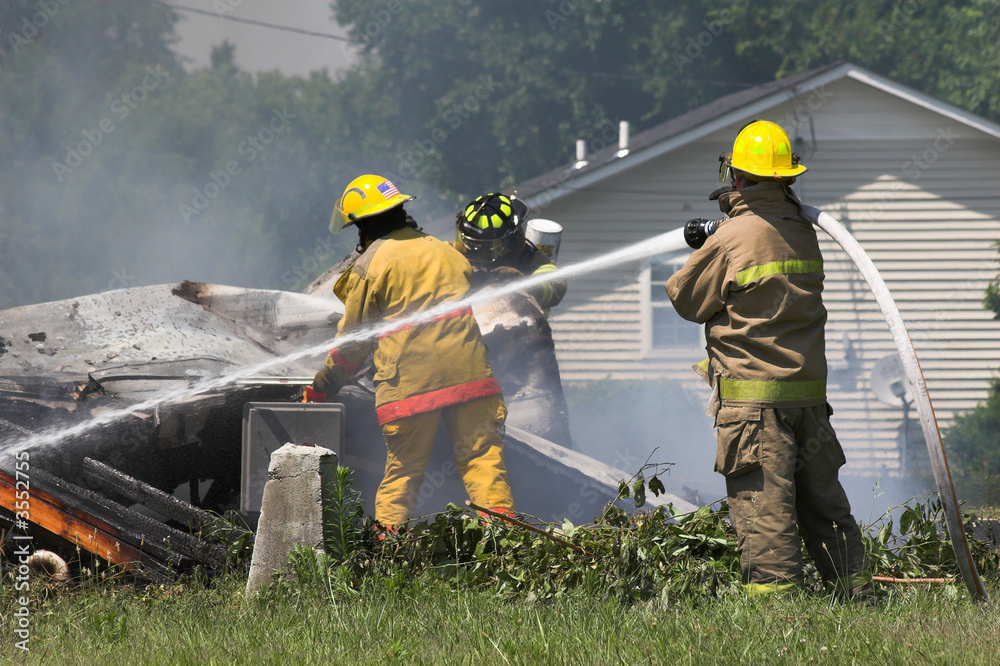 Fire fighters look for victums in debree of burned out home Fire fighters look for victums in debree of burned out home