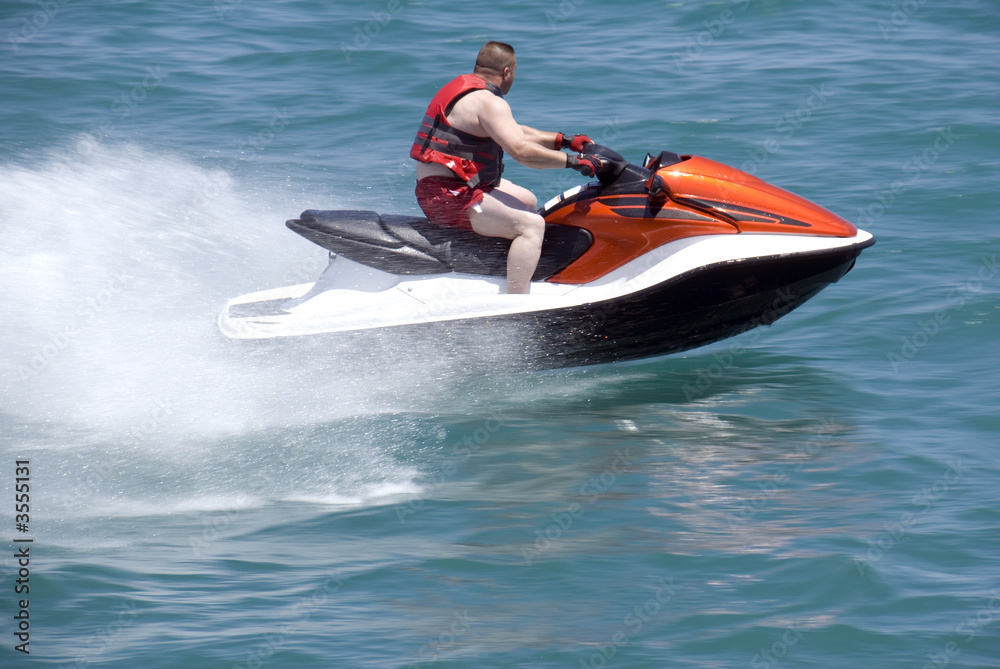 A man riding a late model jet boat.
