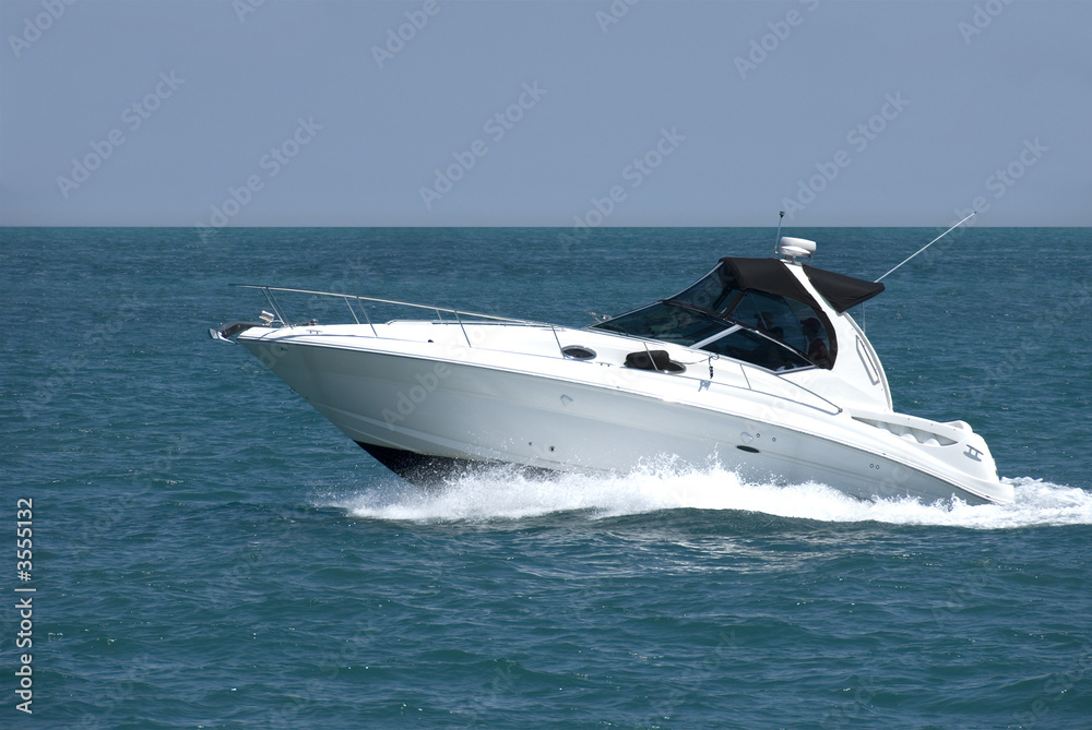 A white speedboat at the height of summer.