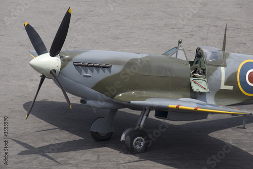 Obraz na płótnie A British Spitfire fighter plane stands ready for action.