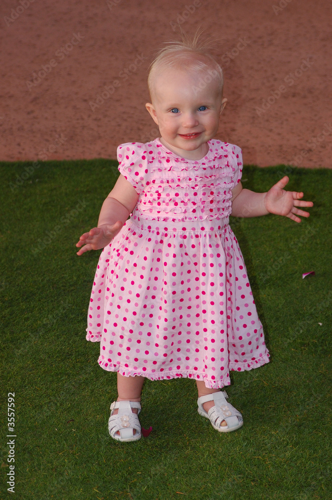 Happy baby walking on green grass in hawaii. Happy baby walking on green grass in hawaii.