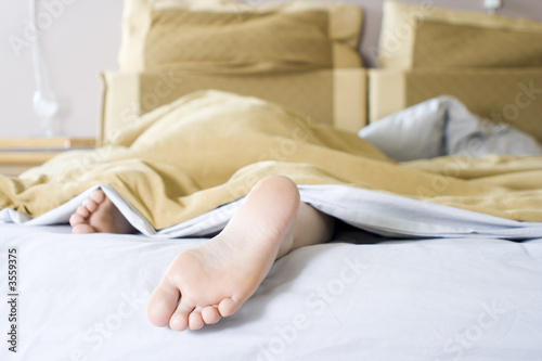 Girl lazying in bed on a Sunday morning