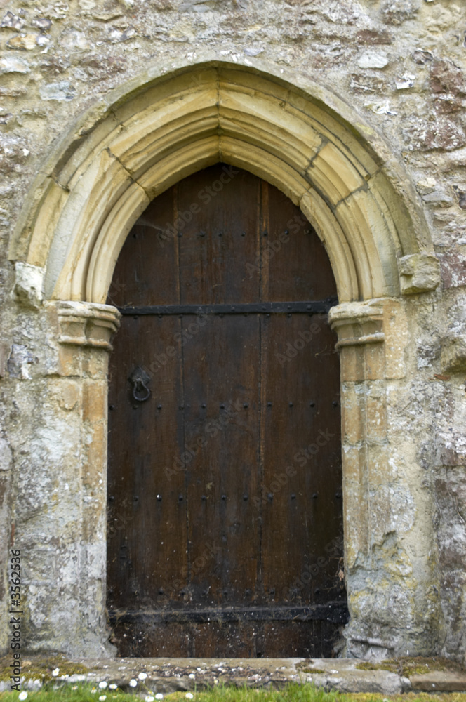 A church door with a stone arch