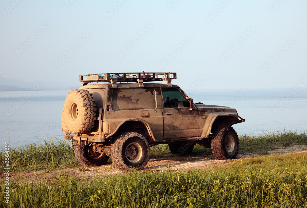 jeep on shore in sunset rays jeep on shore in sunset rays
