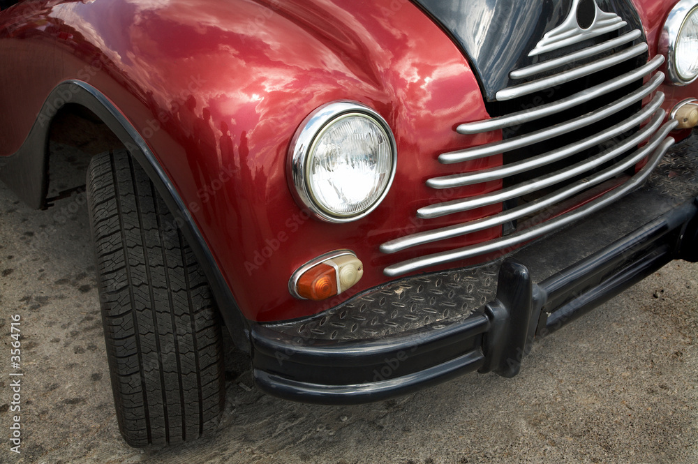 The beautiful and old red car on asphalt