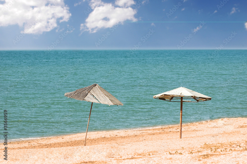 Two parasols on the beach in summer