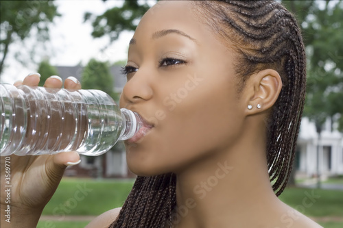 Young Woman Drinking from a Bottle of Water