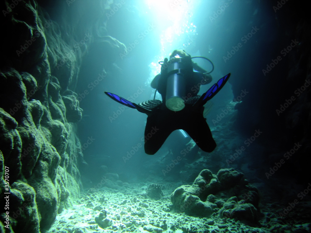diver in the cave and sunlight