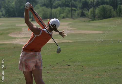 Lady golf swing action at practice ground