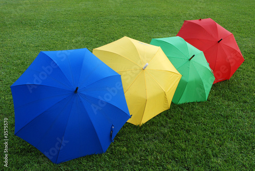 Colorful umbrellas on the football field 