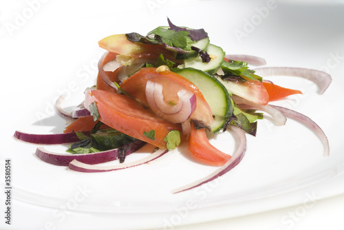 Salad from tomatoes and cucumber with green and onion