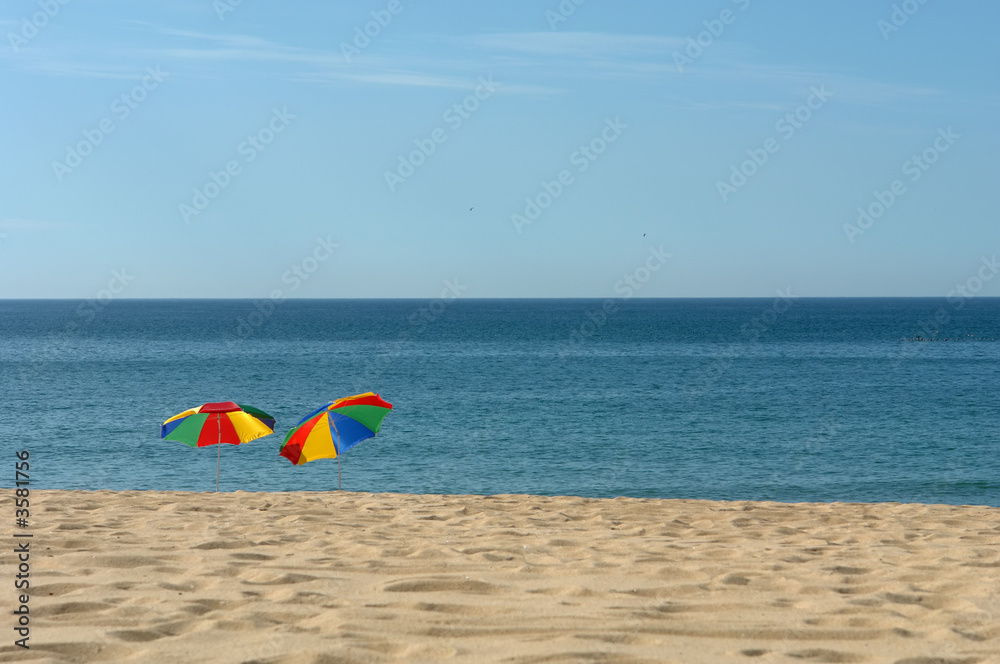 colorful beach umbrellas on the beach in the south of portugal colorful beach umbrellas on the beach in the south of portugal
